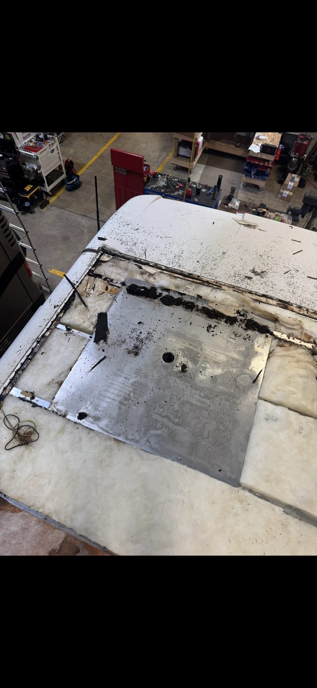 RV roof before repair showing water damage and deterioration